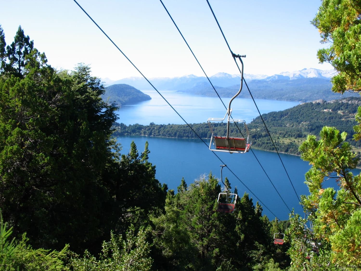 A chairlift climbing Cerro Campanario with Lake Nahuel Huapi below