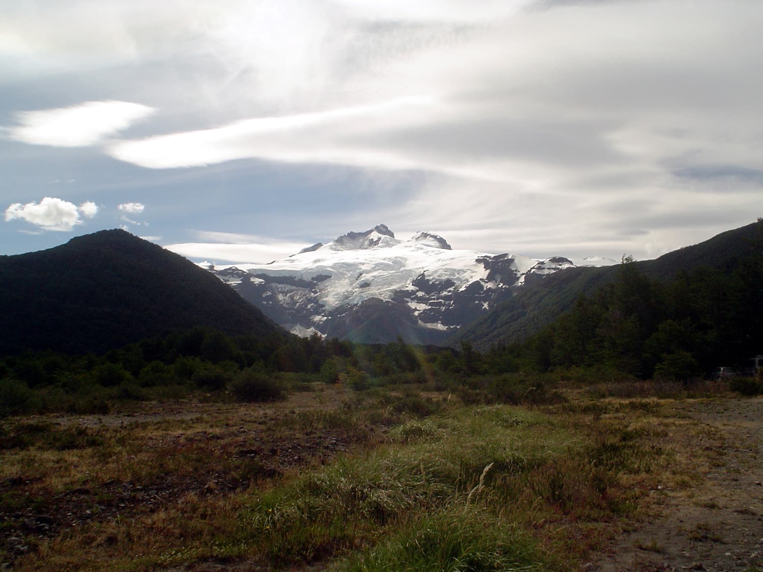 The snow-covered summit of Cerro Tronador seen from the meadows of Pampa Linda