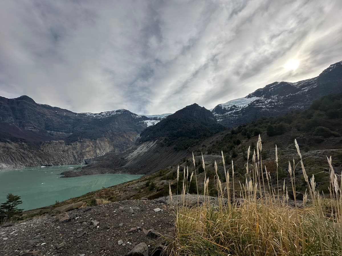 The grey, debris-covered Ventisquero Negro glacier and its lake below Cerro Tronador